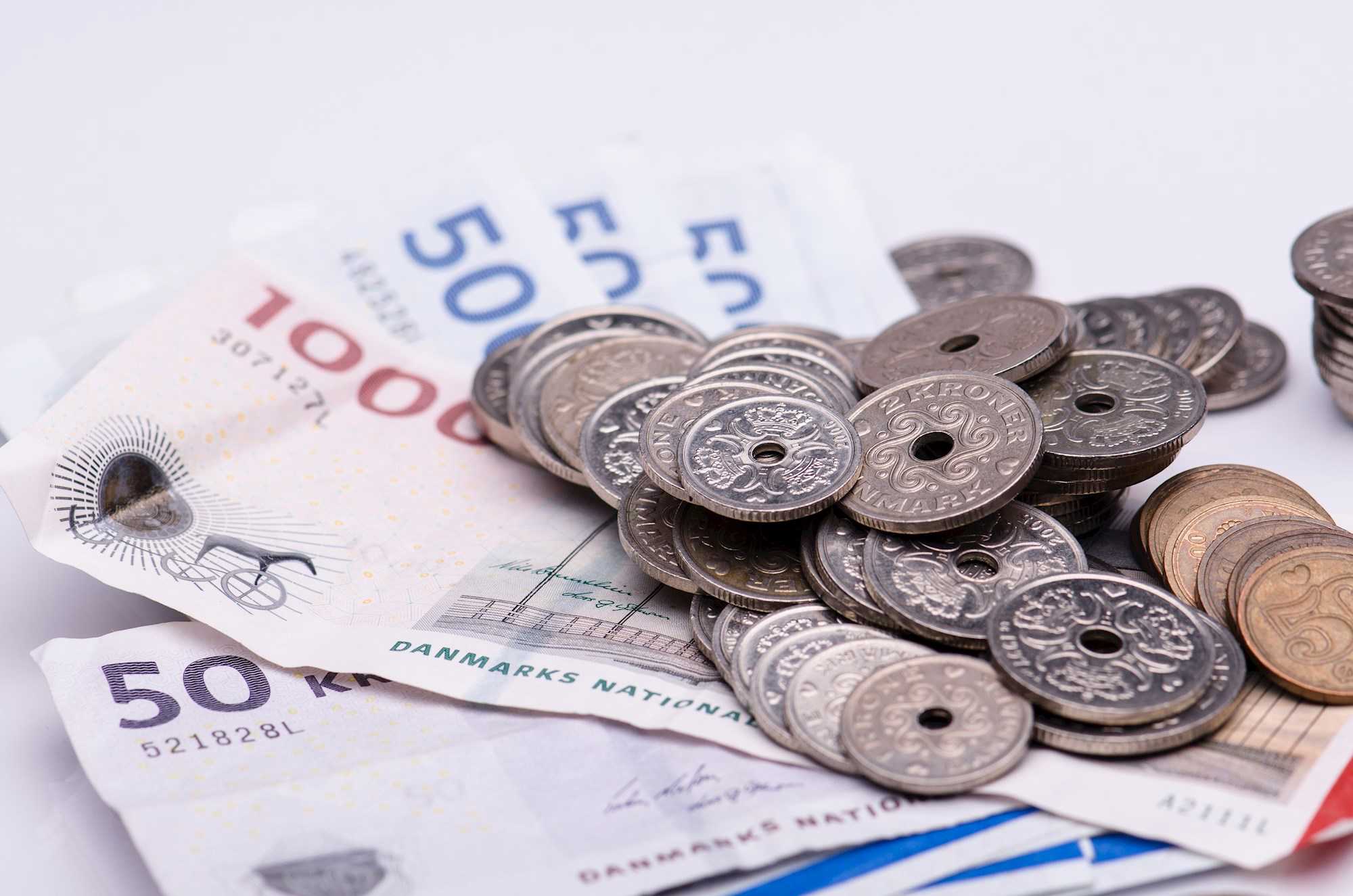 Indbetaling af skat gengivet ved en bunke mønter og pengeselder